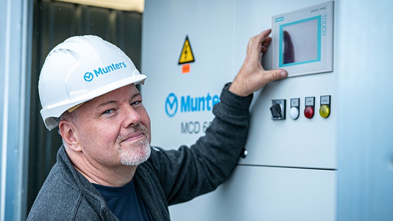 A Munters worker inspecting a Munters dehumidifier | Munters